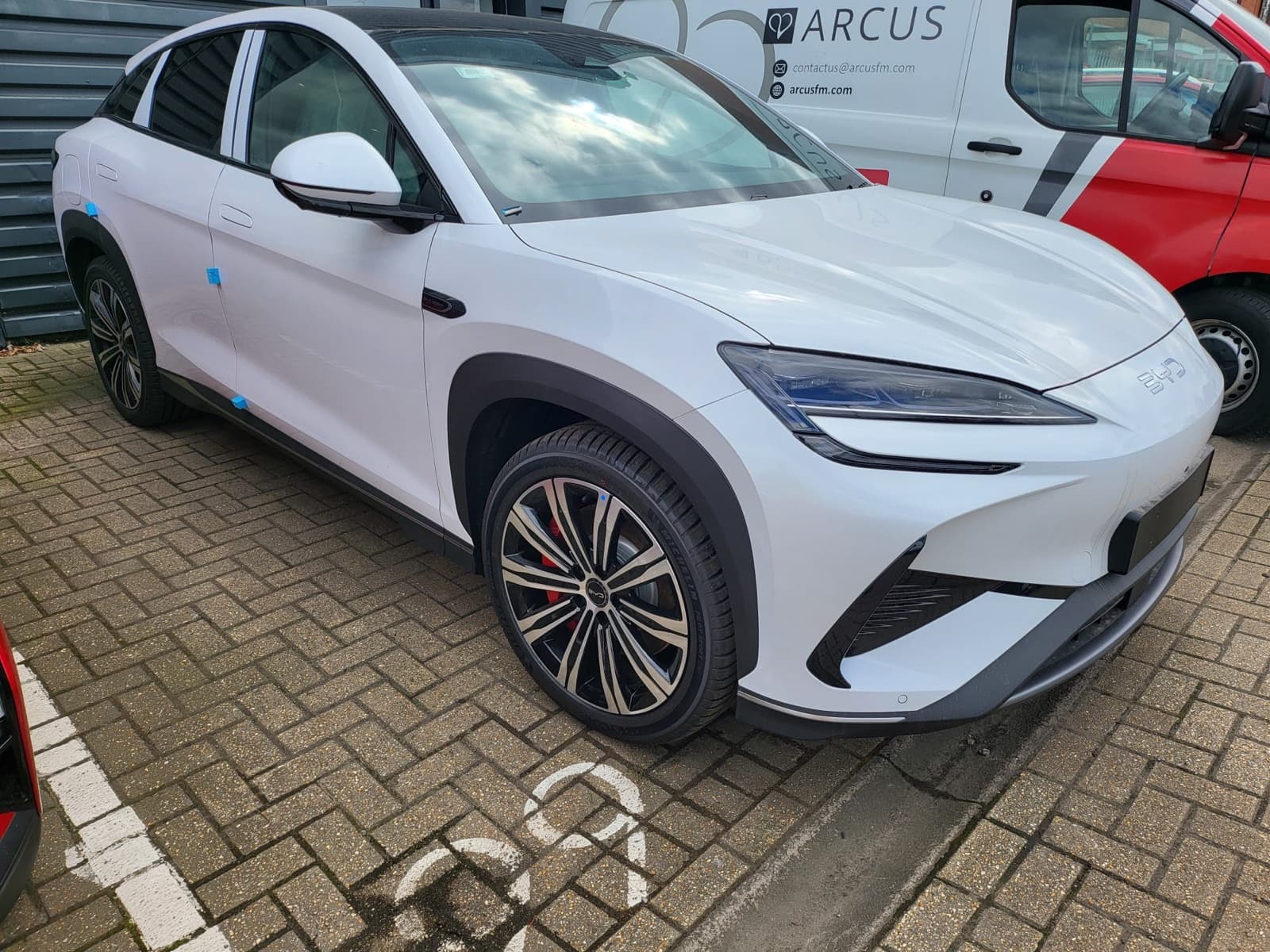 White crossover SUV, front three-quarter view