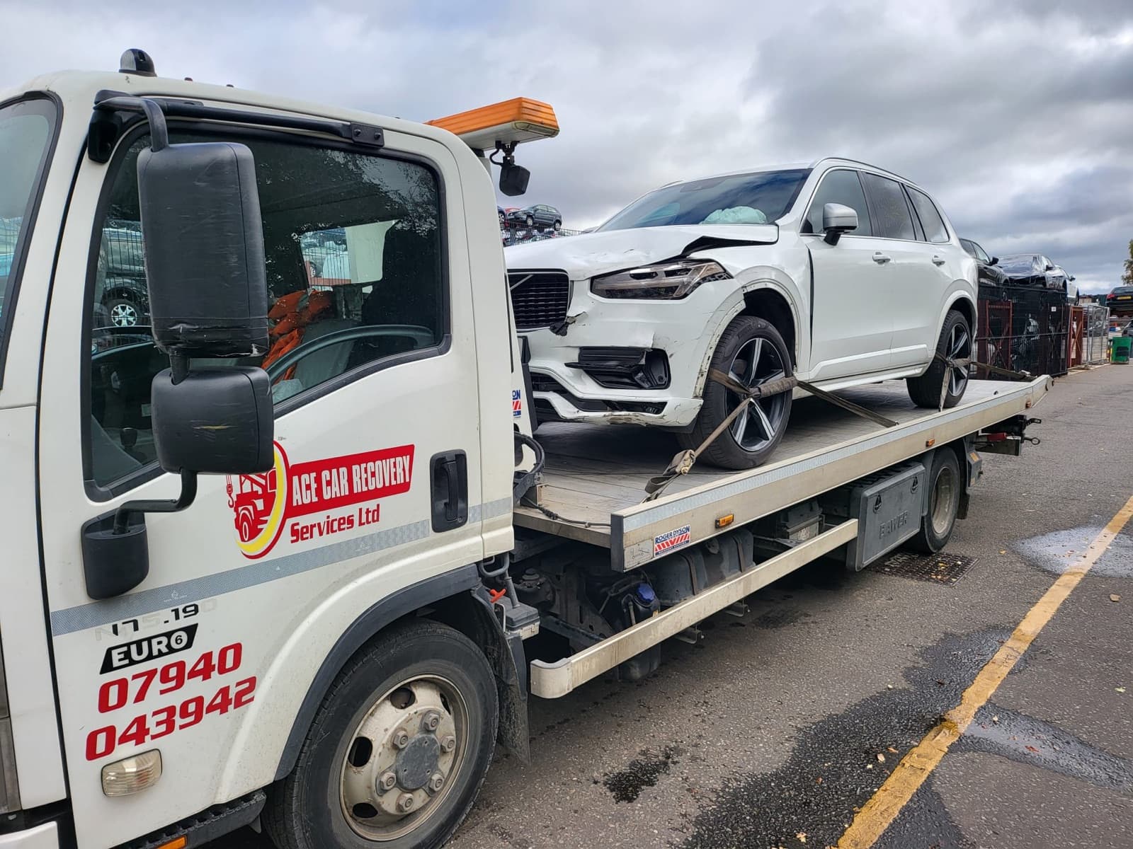 Ace Car Recovery truck carrying a damaged SUV